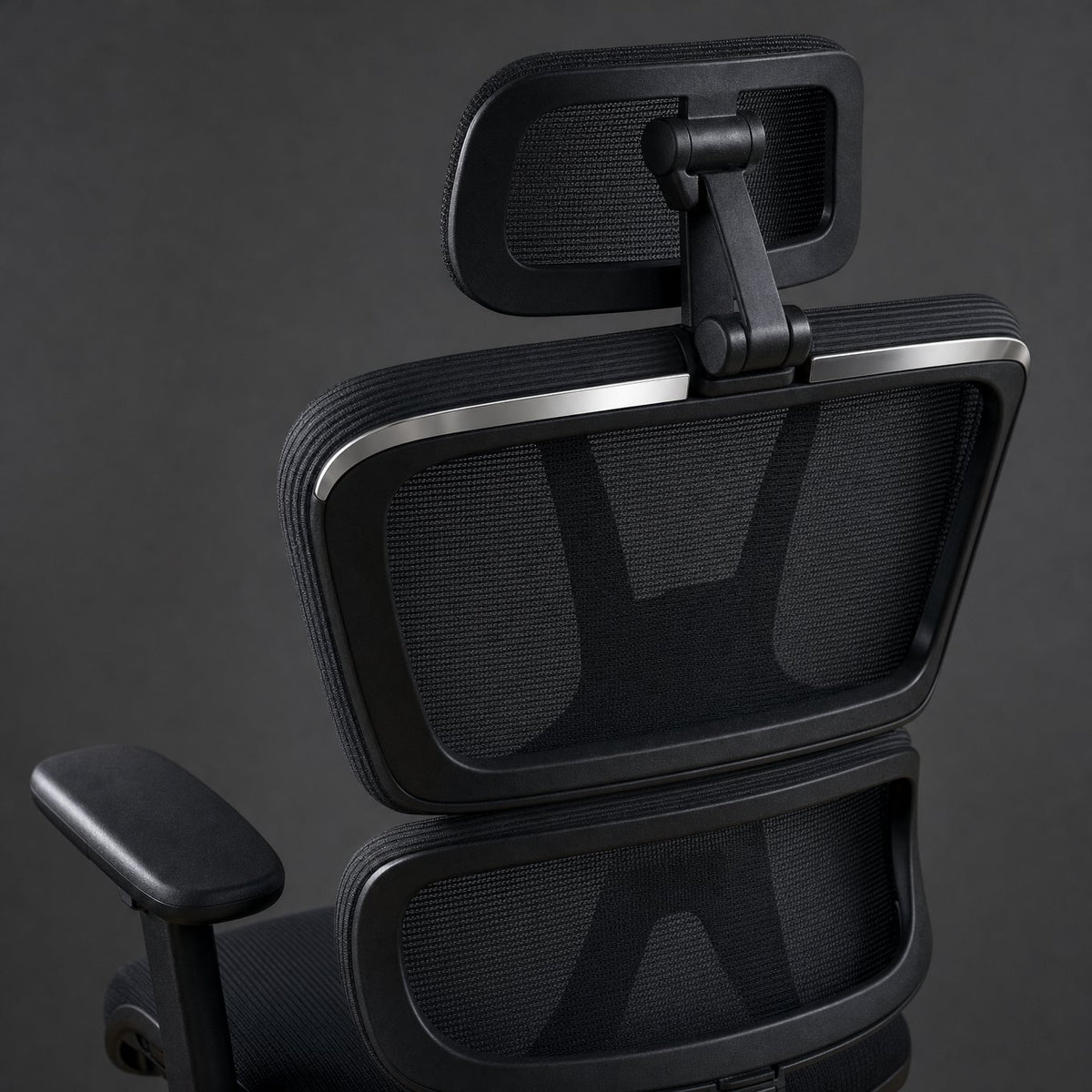Close-up of the pivoting mesh headrest and the two-section mesh backrest from behind