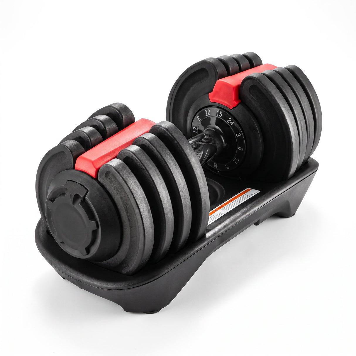 Adjustable dumbbell in black with red locking levers and dial weight selector, seated in its cradle base on a white background