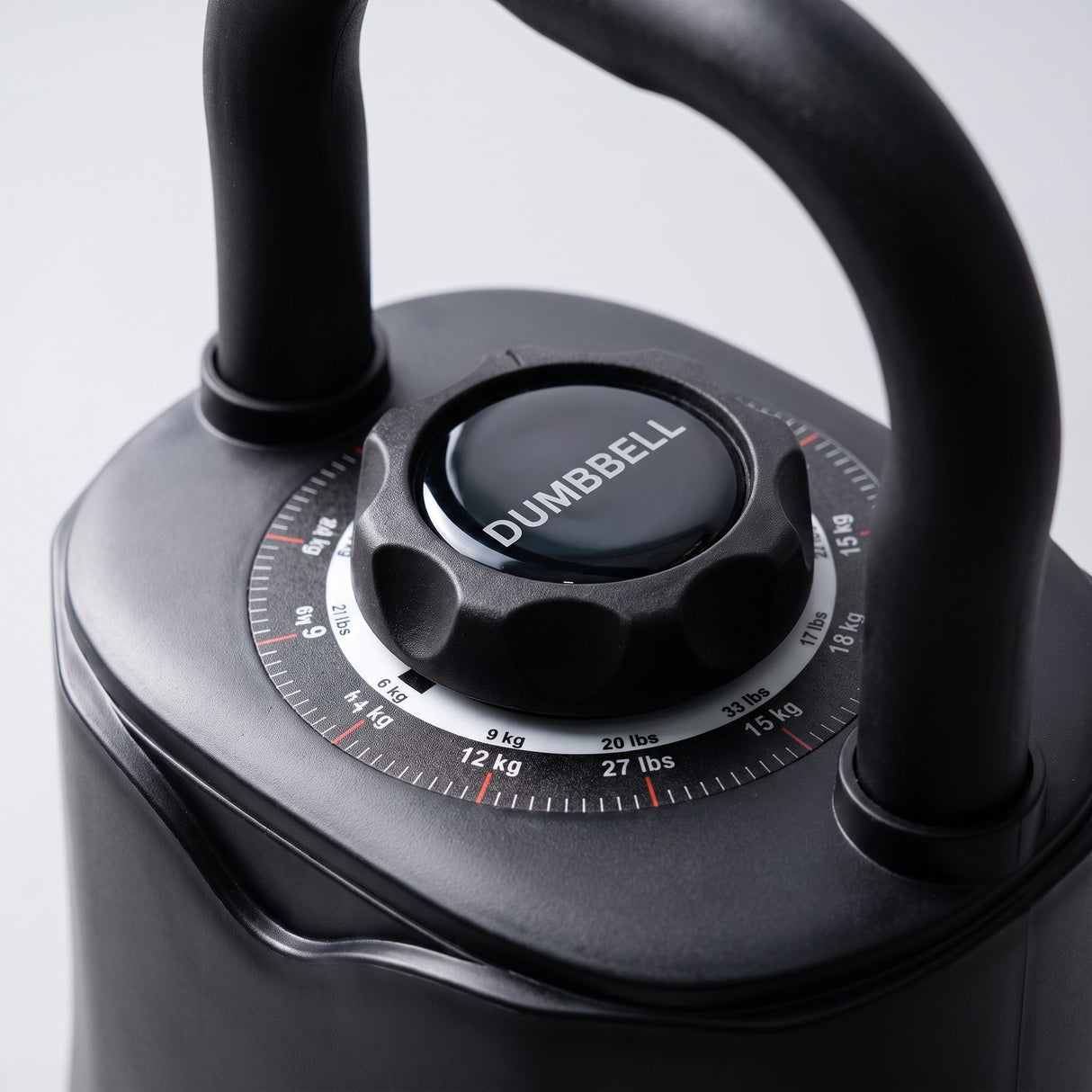 Close-up of the adjustable kettlebell weight selection dial showing kg and lbs markings