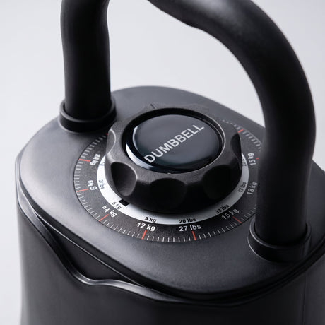 Close-up of the adjustable kettlebell weight selection dial showing kg and lbs markings