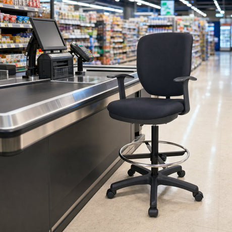 Cashier chair with footrest ring positioned behind a supermarket checkout counter