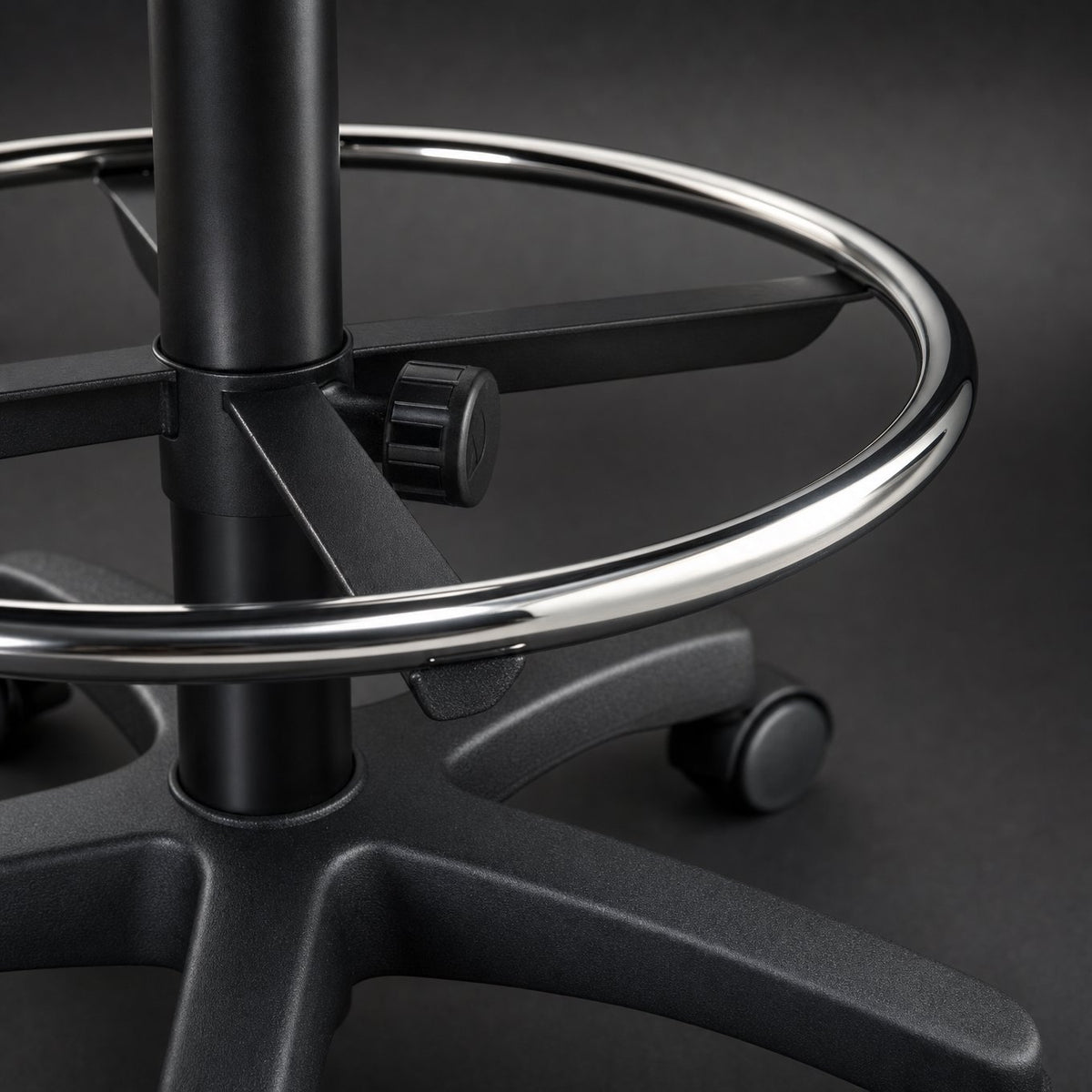 Close up of chrome footrest ring, mounting bracket and height adjustment knob on cashier chair