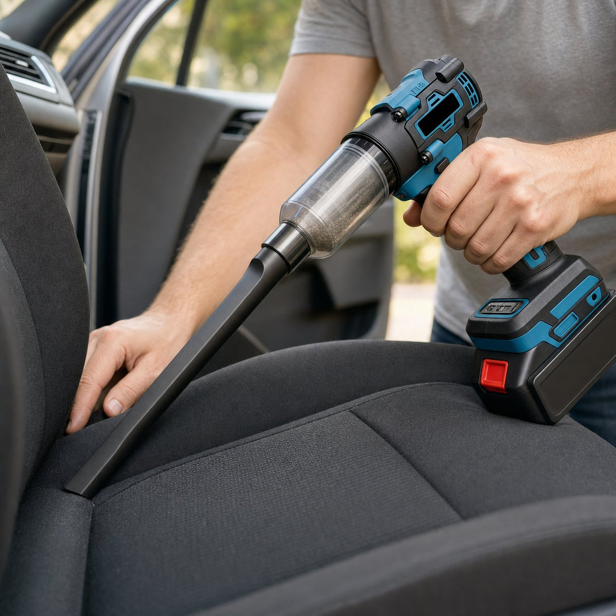 Cordless blower vacuum being used with a crevice nozzle to clean a car seat