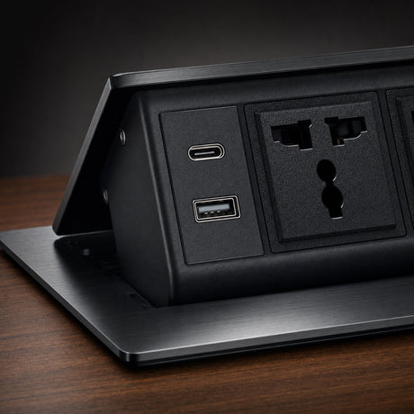 Close up detail of desktop socket USB Type C and USB Type A charging ports beside a universal AC outlet