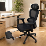 Black mesh office chair at a desk with the footrest extended forward on its chrome tube frame