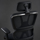 Close-up of the pivoting mesh headrest and the two-section mesh backrest from behind