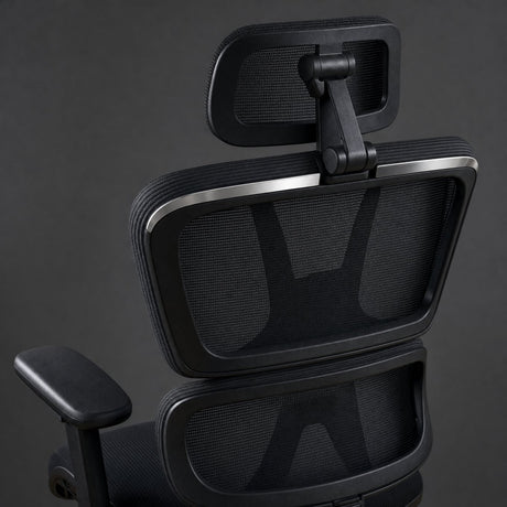 Close-up of the pivoting mesh headrest and the two-section mesh backrest from behind