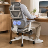 Grey ergonomic mesh office chair in use at a desk with the lumbar massage running