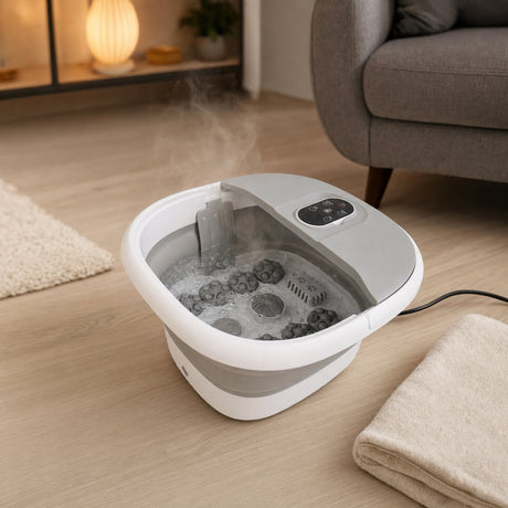 Folding foot spa filled with warm water in front of an armchair in a living room