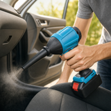 Cordless air blower gun being used to blow dust out of a car interior