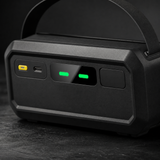 Close up of jump starter control panel showing USB-C input and green status indicator lights
