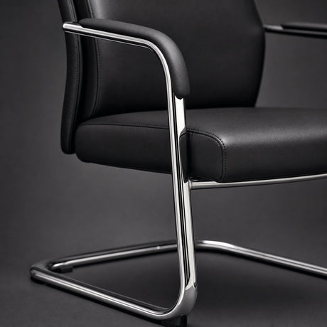 Close up of conference chair padded armrest, stitched black upholstery and polished chrome cantilever frame