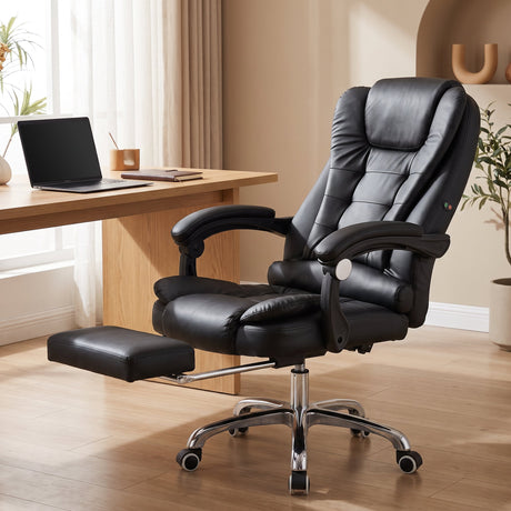 Black leather massage office chair reclined with leg rest in a modern home office - BAS Kuwait