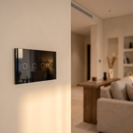 4 Gang black glass smart touch switch installed on a modern wall