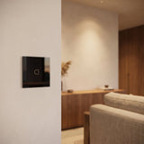 1 Gang black glass smart touch switch installed on a modern wall