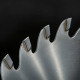Close up of widely spaced carbide tipped teeth and deep gullets on a 24 tooth saw blade