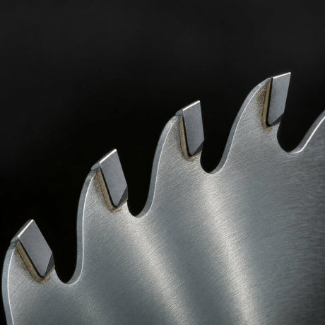 Close up of widely spaced carbide tipped teeth and deep gullets on a 24 tooth saw blade